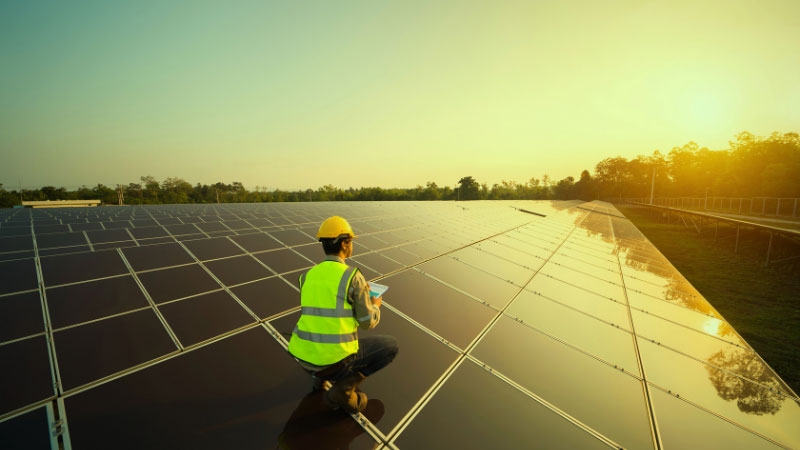 Man sitting on Solar Panel